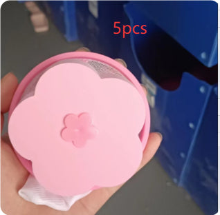 Blue floating laundry pet hair catcher in washing machine